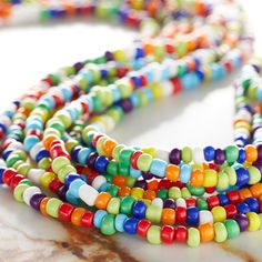 "Get the Multicolored Glass Seed Rondel Beads, 6/0 by Bead Landing at Michaels. Combine these colorful beads along with some metallic spacers to create a multi-strand necklace. Combine these colorful Bead Landing glass beads along with some metallic spacers to create a multi-strand necklace. These beads can also be used to embellish various DIY craft projects. Details: Multicolor 6/0 bead size 112\" (284 cm) string length 100% glass | Multicolored Glass Seed Rondel Beads, 6/0 by Bead Landing™ | Strung Beads, Michael Store, Yarn Projects, Multi Strand Necklace, Strand Necklace, Multi Strand, Loom Beading, Bead Weaving, Embroidered Friendship Bracelet