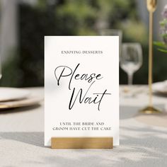 a place card sitting on top of a table next to a wine glass and silverware