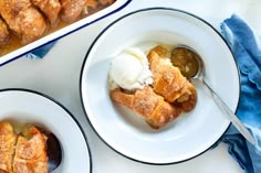 two plates filled with dessert next to a casserole dish on a white table