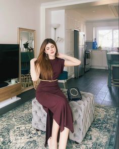 a woman sitting on top of a couch in a living room