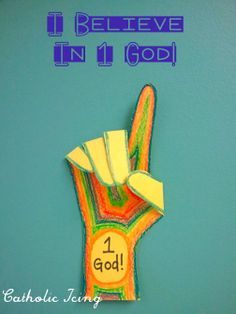 a hand made out of paper with the words i believe in 11 god