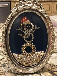 an ornate frame with pearls and bead work on it