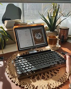 a laptop computer sitting on top of a wooden table next to a keyboard and mouse