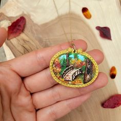 This hand-sculpted pendant is unique, handmade, and one of a kind. Perfect for nature lovers who want a statement piece that is both whimsical and sophisticated.  It is made of 100% polymer clay, with each piece carefully sculpted to create a painting. SIZE The pendant is about 1.5 inches in height and 1.75inches wide.  The necklace chain is adjustable between 16-19 inches. MATERIALS Made from polymer clay.   Each piece is unique and lovingly made by hand, so please allow slight imperfections in Handmade Nature-inspired Polymer Clay Jewelry, Nature-inspired Pendant Necklace With Hand Painted Details, Hand Painted Nature-inspired Pendant Necklace, Nature-inspired Hand Painted Pendant Necklace, Hand Painted Resin Jewelry For Gifts, Handmade Resin Jewelry Nature-inspired, Nature-inspired Pendant Jewelry For Crafting, Whimsical Handmade Necklace For Gift, Nature-inspired Round Jewelry For Crafting