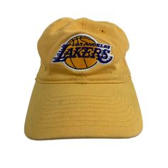 You are purchasing a Pre-Owned Adidas Los Angeles Lakers Hat Cap Pre-Owned Yellow One Size. It has Regular Wear Lots of Life Left. This cap will compliment any outfit.  Ships with USPS First Class Shipping. Free Returns.  All Orders Prior to 12:00 PM (Noon) will ship the same business day! Adidas Casual Hat For Sports Events, Casual Adidas Hat For Sports Events, Vintage Adjustable Dad Hat For Sports, Adjustable Vintage Dad Hat For Sports, Vintage Visor Hat With Embroidered Logo, Adidas Cap For Sports Events, Adidas Sports Event Hats, Adidas Sports Cap, Vintage Dad Hat For Sports