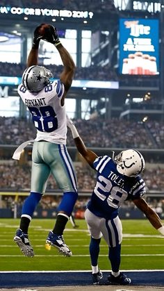 two football players jumping up in the air