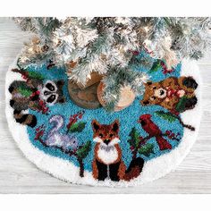 a christmas tree skirt with animals on it