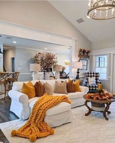 a living room filled with furniture and a chandelier