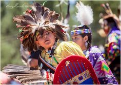 native american people in colorful clothing and headdress