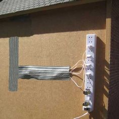 an electrical device is plugged in to the side of a wall with wires attached