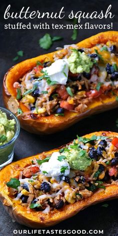 two stuffed sweet potatoes topped with black beans, guacamole and sour cream