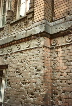 an old brick building with peeling paint on it