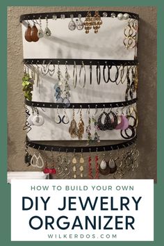 a jewelry organizer hanging on the wall with text overlay that reads how to build your own diy jewelry organizer