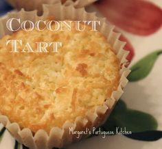 a close up of a muffin on a plate with the words coconut tart