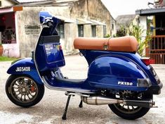 a blue scooter is parked on the street