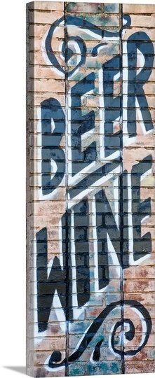 graffiti on the side of a building that says beer and wine written in large letters