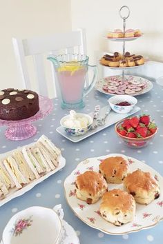 a table topped with lots of food and desserts