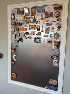 a refrigerator covered in magnets and pictures on the wall next to a toilet bowl