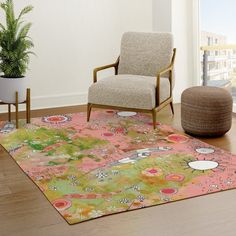 a living room with a chair, rug and potted plant