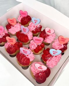 valentine's day cupcakes in a box with pink frosting and hearts