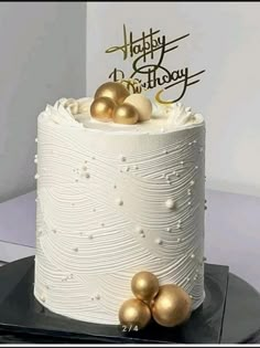 a white cake with gold decorations on top