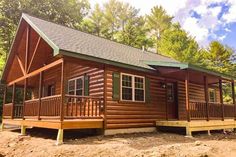 a log cabin in the woods on a sunny day