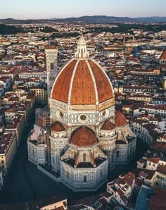 an aerial view of the dome of a large building with red and white tiles on it