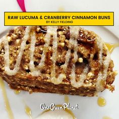 a close up of a plate of food with syrup on it and the words raw lucuma and cranberry cinnamon buns