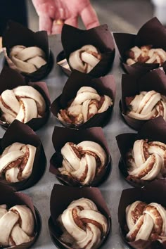 there are many cupcakes that have been wrapped in brown paper on the table