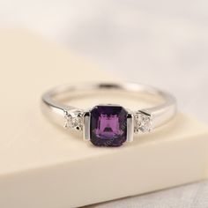 All HANDMADE ITEMS SHIP IN APPROX 8 DAYS This asscher cut Amethyst ring is perfect daily jewelry! The additional design of two tiny round shaped CZ by the side of main stone,make this ring the unique design! Most Amethyst gemstones come in shades of purple, but you can find a variety of color in the gem from light to dark. The most sought after color tends to be a rich, royal purple. The popular belief of Amethyst is that it promotes clarity of mind. Main Stone: Real natural Amethyst Main Stone Bezel Set Amethyst Ring For Promise, Silver Amethyst Promise Ring With Bezel Setting, Round Amethyst Promise Ring With Bezel Setting, Silver Heart-shaped Amethyst Ring For Anniversary, Silver Amethyst Ring With Heart-cut Center Stone, Half Bezel Setting, Unique Engagement, Daily Jewelry, Wedding Rings Solitaire