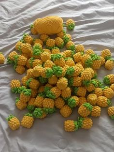 a pile of yellow pineapples sitting on top of a white sheet