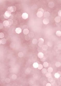 a blurry pink background with small circles