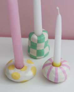 three candles sitting next to each other on a table