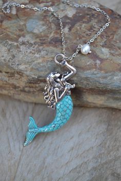 PLEASE read my shop announcement before placing an order so you know what to expect right now. Plus, when ordering from outside Europe, don't forget to provide a phone number for the courier to ensure the fastest and smoothest delivery. Large silver mermaid pendant necklace highly detailed, tail painted in a verdigris patina effect, and freshwater pearl dangle. So beautiful and whimsical mermaid jewelry... Stainless steel chain and findings High quality Short necklace: Chain length is about 16 i Ocean-inspired Pendant Necklace With Lobster Clasp, Whimsical Pearl Charm Jewelry For Gifts, Whimsical Pearl Charm Jewelry As Gift, Elegant Mermaid Jewelry With Lobster Clasp, Ocean-inspired Mermaid Shape Sterling Silver Jewelry, Ocean-inspired Mermaid Sterling Silver Jewelry, Ocean-inspired Sterling Silver Mermaid Jewelry, Silver Sterling Silver Mermaid Necklaces, Nickel Free Ocean-inspired Pendant Jewelry