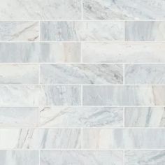 a white marble tile wall that looks like it has been made out of different types of tiles