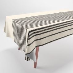 a black and white striped tablecloth with wooden legs