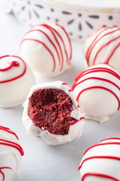 red velvet cake truffles with white frosting and sprinkles on them