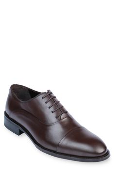 Handmade of smooth leather, this cap-toe dress shoe with a classic oxford silhouette offers a sophisticated, elegant look. Leather upper and lining/synthetic sole Made in Turkey Classic Oxford Lace-up Shoes With Rubber Heel Cap, Classic Cap Toe Business Lace-up Shoes, Semi-formal Cap Toe Oxfords With Branded Insole, Cap Toe Oxford Lace-up Shoes For Business, Classic Cap Toe Oxfords With Leather Sole, Formal Cap Toe Lace-up Shoes With Goodyear Welt, Cap Toe Oxfords With Goodyear Welt Construction For Business, Business Cap Toe Oxfords With Goodyear Welt Construction, Elegant Oxford Derby Shoes With Cap Toe