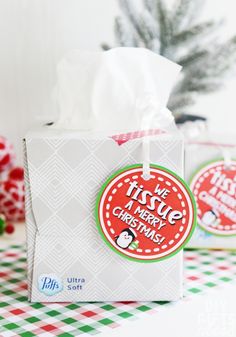 two christmas gift bags sitting on top of a table