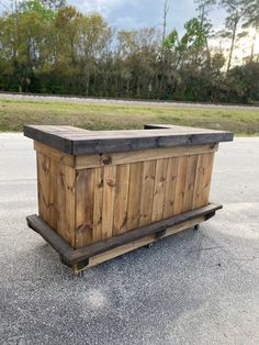 a large wooden box sitting on top of a parking lot