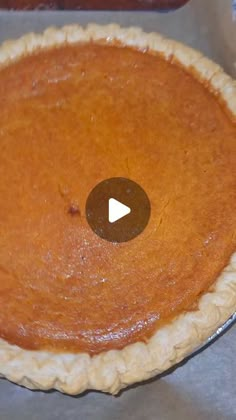 an uncooked pie sitting on top of a metal pan with a video screen