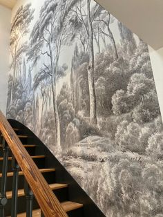 a staircase leading up to a large mural on the wall