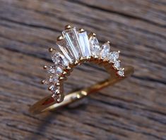 a diamond ring sitting on top of a wooden table