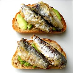 two pieces of bread with fish on them