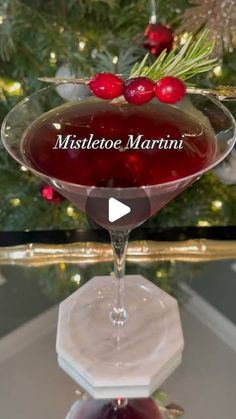 a martini glass sitting on top of a table next to a christmas ornament