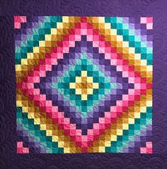 a colorful quilt on a purple background