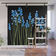 blue flowers on black wall mural in living room with ladder and potted plant next to it