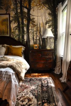 a bed sitting next to a window in a room with a rug on the floor