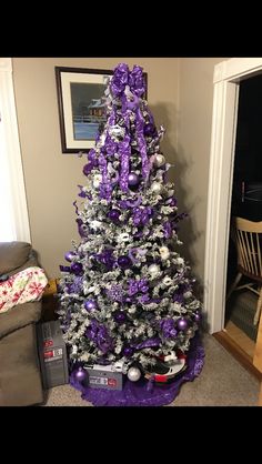 a purple and silver christmas tree in a living room