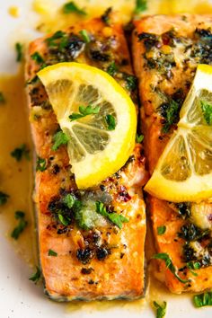 grilled salmon with lemon and herbs on a white plate